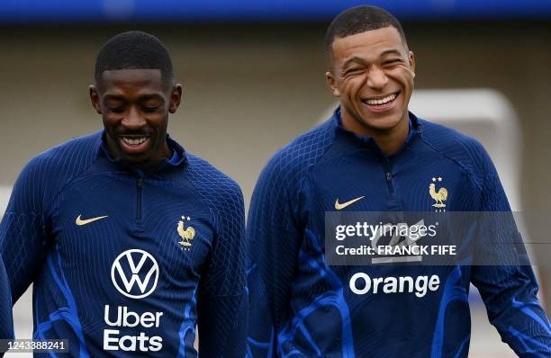 France's forward Ousmane Dembele jokes with France's forward Kylian Mbappe during a training session in Clairefontaine-en-Yvelines on September 20,...