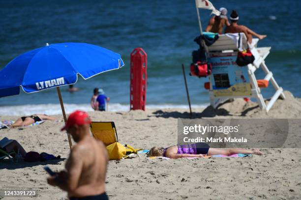 Beach goers sunbathe at Rehoboth Beach on September 20, 2022 in Rehoboth Beach, Delaware. Although no such flights have been confirmed, reports on...