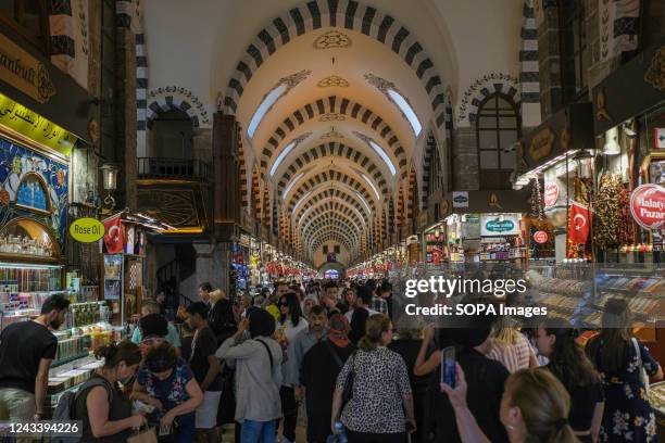 General view of the Grand Bazaar with locals and foreigners walking around the bazaar. Located in the Eminönü district of Istanbul, the Historical...