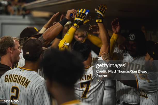 Ha-seong Kim of the San Diego Padres celebrates in the dugout after hitting a home run in the fourth inning against the St. Louis Cardinals at PETCO...