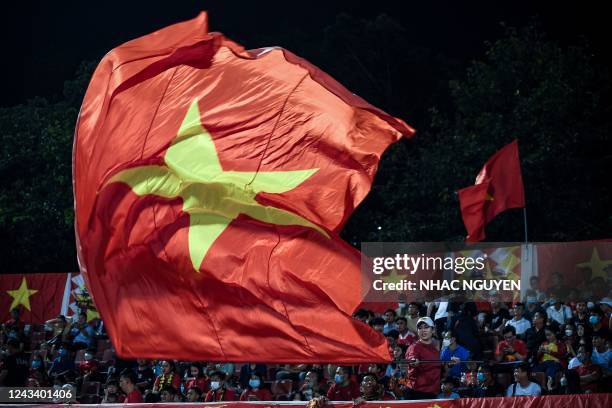 Supporter waves a giant flag of Vietnam before the Hung Thinh International Football Tournament 2022 friendly football match between Vietnam and...