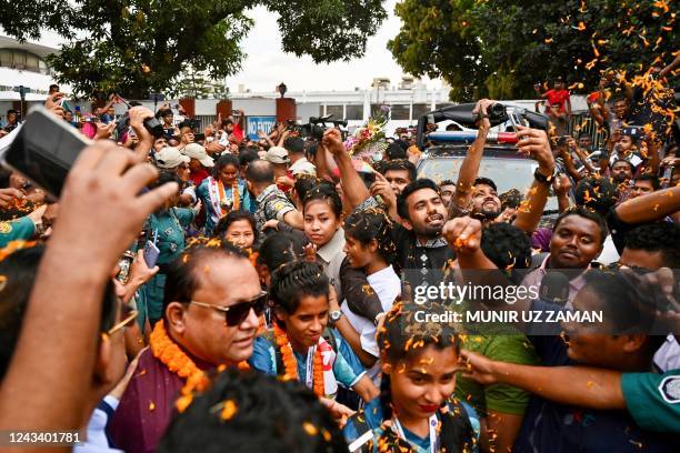 Supporters welcome members of the Bangladesh womens football team, who won the SAFF Women's Championship 2022 in Nepal, outside the aiport before a...