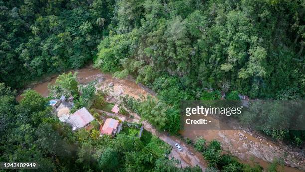 This aerial picture taken on September 20 in Utuado, Puerto Rico, after the the power went out with the passage of Hurricane Fiona. - Hurricane Fiona...