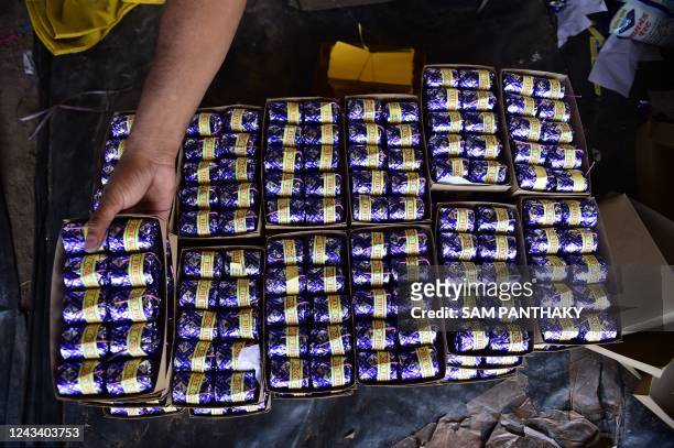 Workers stacks finished firecrackers at a workshop ahead of 'Diwali' festival on the outskirts of Ahmedabad on September 21, 2022.