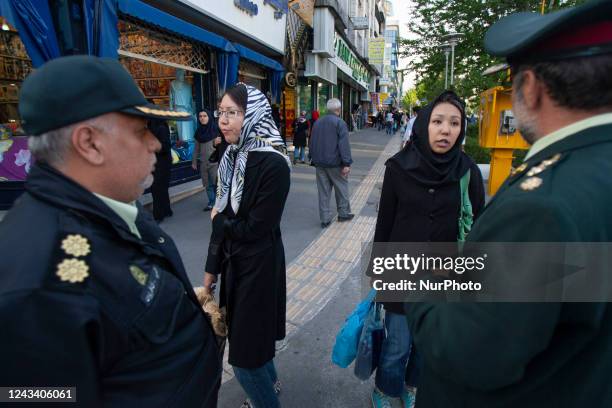 April 23, 2007 file photo shows, A woman speaks with two morality policemen in Tehran. Thousands of Iranians protest the death of Mahsa Amini, Also...