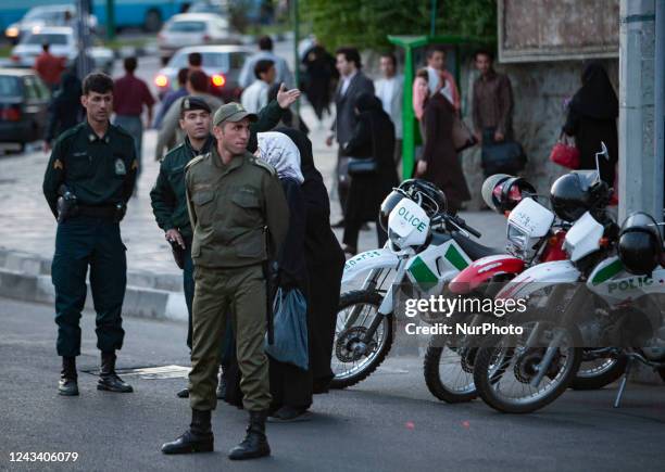 Iranian morality policemen stand guard while monitoring an area in Tehran. Thousands of Iranians protest the death of Mahsa Amini, Also known as...