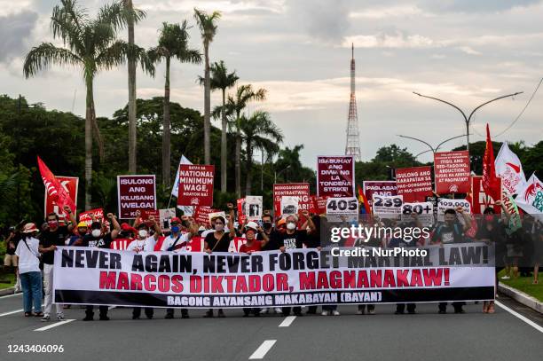 Filipino activists march during a protest commemorating the 50th anniversary of Martial Law, at the University of the Philippines, in Quezon City,...