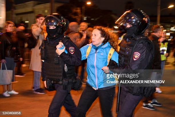 Police officers detain a woman in Moscow on September 21 following calls to protest against partial mobilisation announced by President Vladimir...