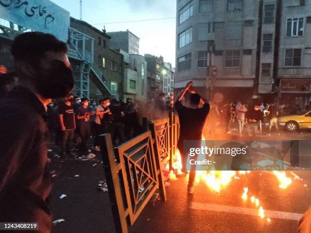 Picture obtained by AFP outside Iran on September 21 shows Iranian demonstrators taking to the streets of the capital Tehran during a protest for...