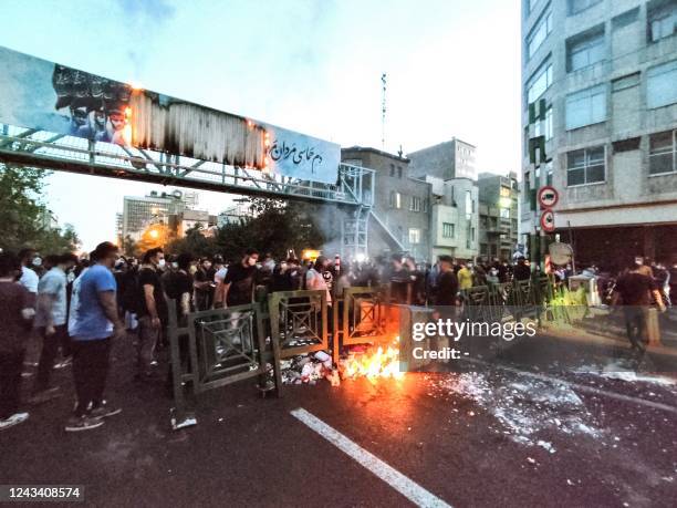 Picture obtained by AFP outside Iran on September 21 shows Iranian demonstrators taking to the streets of the capital Tehran during a protest for...