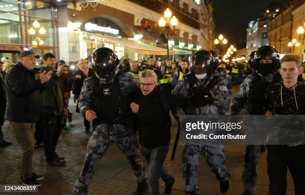 Russia Police officers, one of them with letter "Z" on his uniform, a symbol of support of the military invasion in Ukraine, detains a protester...
