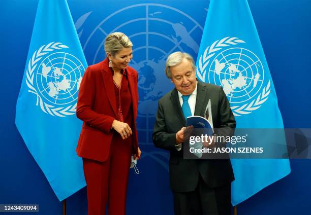 Queen Maxima of the Netherlands looks at a copy of the United Nations Secretary-General's Special Advocate for Inclusive Finance for Development...
