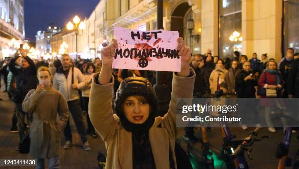 An activist participates in an unsanctioned protest at Arbat Street September 21, 2022 in Moscow, Russia. The sign plays on the word mobilization as...