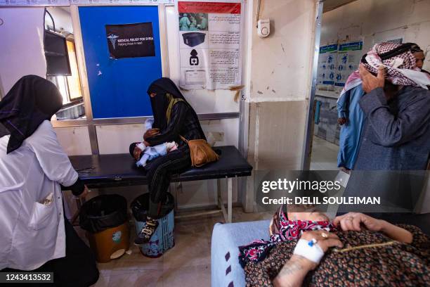 People suffering from cholera receive treatment at the Al-Kasrah hospital in Syria's eastern province of Deir Ezzor, on September 17 affected by the...