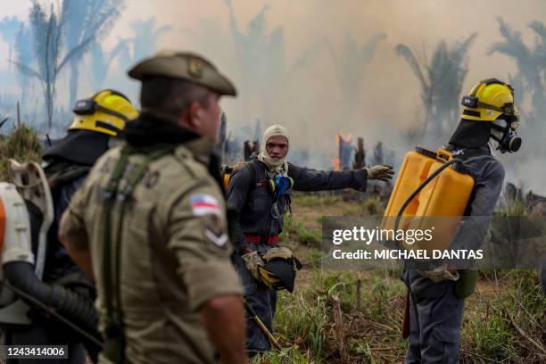 Firefighters and volunteers combat a fire on the Amazonia rainforest in Apui, southern Amazonas State, Brazil, on September 21, 2022. - According to...