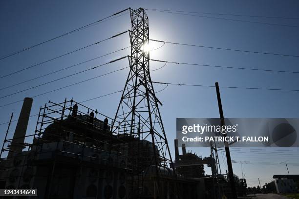 The sun shines above a natural gas-fired electric power generating unit from the 1950s, cooled using a seawater once-through cooling system, at AES...