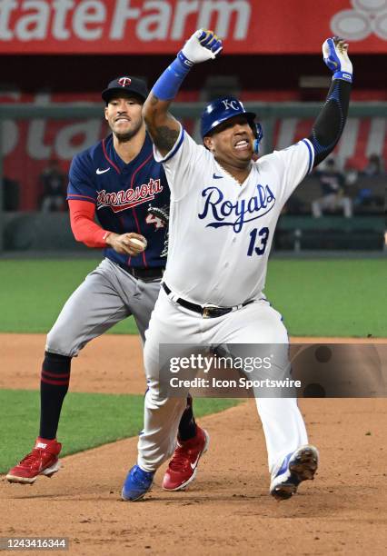 Kansas City Royals catcher Salvador Perez is caught in a rundown by Minnesota Twins shortstop Carlos Correa during a MLB game between the Minnesota...