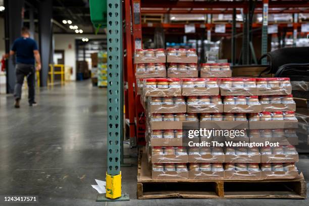 Warehouse staff work around pallets of peanut butter at Connecticut Foodshare on September 14, 2022 in Wallingford, Conn. The price for a trailer of...