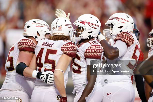 Florida State Seminoles players celebrate after a touchdown during a college football game against the Louisville Cardinals on September 16, 2022 at...