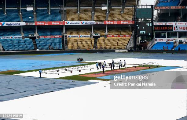 Ground staff mopping up as rain cancelled the India and Australia practice section at Vidarbha Cricket Association Stadium Jamtha on September 22,...