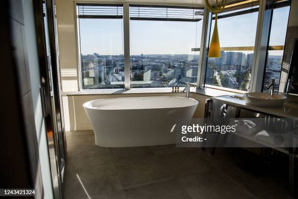 Photograph taken on September 21 shows a bathroom in a hotel overlooking the Paris skyline, as seen from the Tour Duo 2 during the Tours Duo...