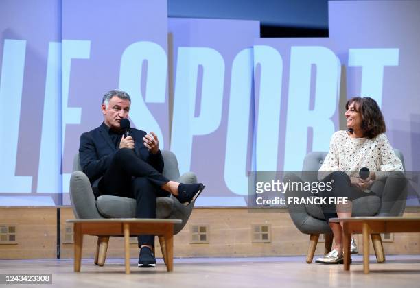 Paris Saint-Germain's French head coach Christophe Galtier and French journalists Nathalie Iannetta participate in a debate on the occasion of an...