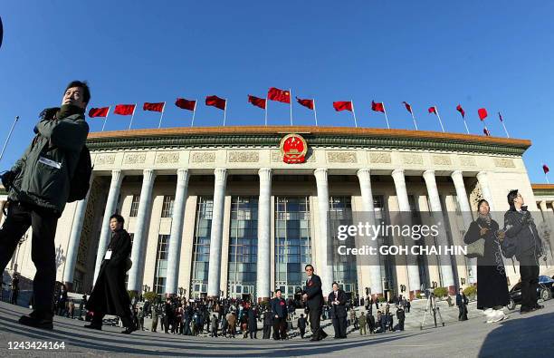 Communist delegates gather in front of the Great Hall of the People prior to the closing session of the 16th Communist Party Congress in Beijing, 14...