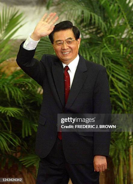 China's Vice President Hu Jintao waves after he was named head of China's ruling Communist Party, taking over as general secretary of the party, 15...