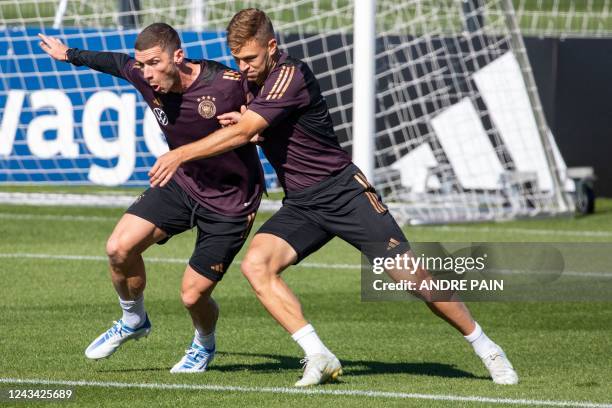 Germany's defender Robin Gosens and midfielder Joshua Kimmich take part in a training session at the DFB Campus in Frankfurt am Main, western...