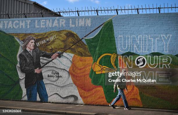 Man walks past a mural calling for Irish unity on the day that the Northern Ireland census was released on September 22, 2022 in Belfast, Northern...