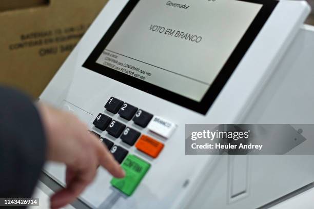 Electoral authoritie shows a blank vote in the electronic voting machine during a sealing operation before being used in the first round of the...