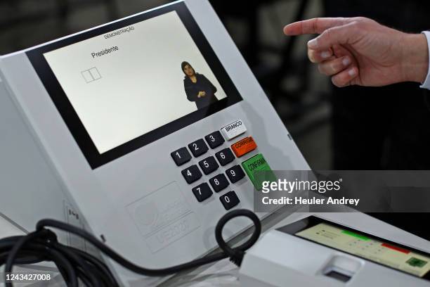 Electoral authoritie tests an electronic voting machine during a sealing operation before being used in the first round of the upcoming Brazilian...