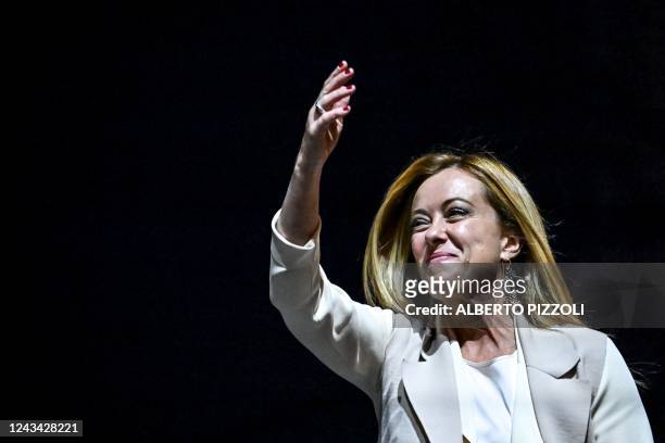 Brothers of Italy party leader Giorgia Meloni gestures as she delivers a speech on stage on September 22, 2022 during a joint rally of Italy's...