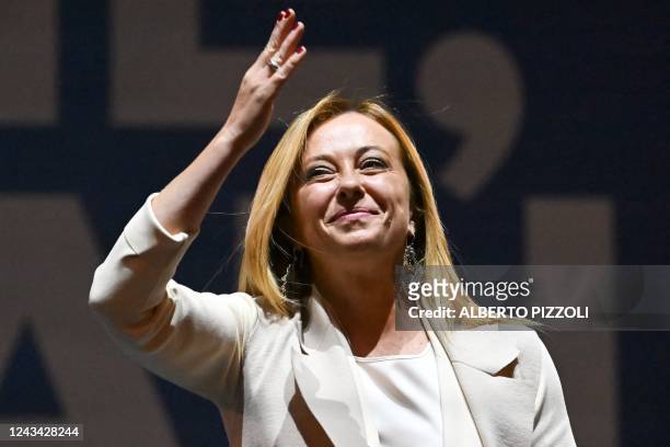 Brothers of Italy party leader Giorgia Meloni gestures as she delivers a speech on stage on September 22, 2022 during a joint rally of Italy's...