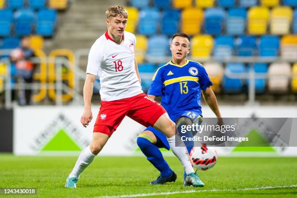 Szczepan Mucha of Poland and Danijel Mijatovic of Bosnia and Herzegovina battle for the ball during the UEFA Under-19 European Championship Qualifier...