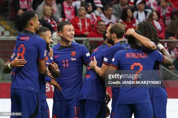 Netherlands' players celebrate forward Cody Gakpo after he scored the team's first goal during UEFA Nations League Group 4 football match between...