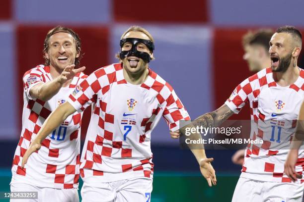 Lovro Majer of Croatia celebrates with teammates Luka Modric and Marcelo Brozovic after scoring their side's second goal during the UEFA Nations...