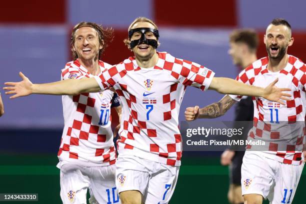 Lovro Majer of Croatia celebrates with teammates Luka Modric and Marcelo Brozovic after scoring their side's second goal during the UEFA Nations...