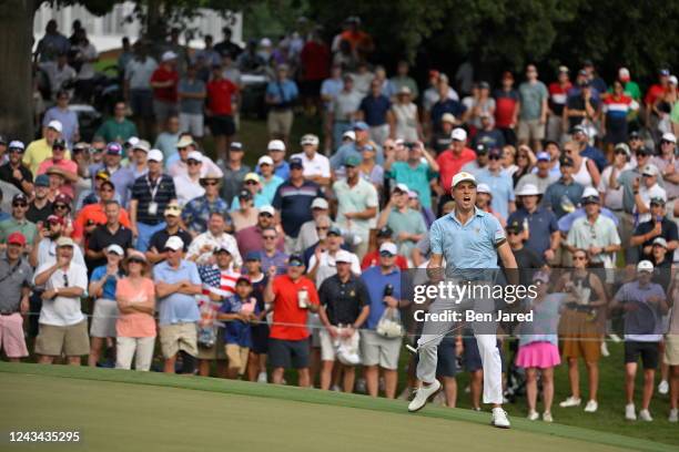 Team member Justin Thomas celebrates making his putt on the 15th hole during the first round of Presidents Cup at Quail Hollow September 22 in...