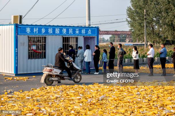 Farmers line up for nucleic acid tests in Hua county, Anyang City, Henan Province, China, Sept 22, 2022.