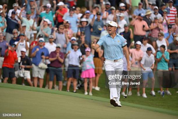 Team member Justin Thomas celebrates making his putt on the 15th hole during the first round of Presidents Cup at Quail Hollow September 22 in...