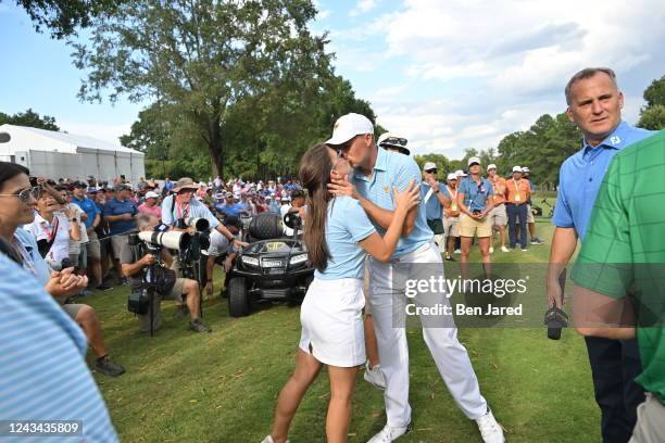 United States Team Member Jordan Spieth kisses his wife Annie Speith on the 17th hole during the first round of Presidents Cup at Quail Hollow...