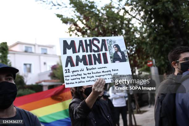 Woman holds a placard in front of the Iranian embassy of Athens for the 22-year-old Kurdish woman Mahsa Amini who was murdered at a police station in...