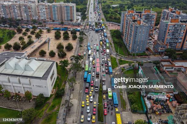 This aerial view shows heavy traffic on an avenue in Bogota, on September 20, 2022. - From dawn, it is an uninterrupted flow: hundreds of cyclists...