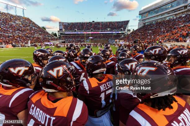 The Virginia Tech Hokies huddle before the start of their game against the West Virginia Mountaineers at Lane Stadium on September 22, 2022 in...