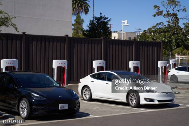 Tesla vehicles are plugged into Tesla charging stations in a parking lot on September 22, 2022 in Santa Monica, California. Tesla is recalling over 1...