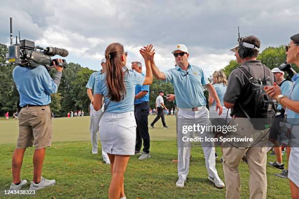 Annie Spieth wife of USA President Cup golfer Jordan Spieth high fives vice captain Zach Johnson after her husband won his match during the 2022...