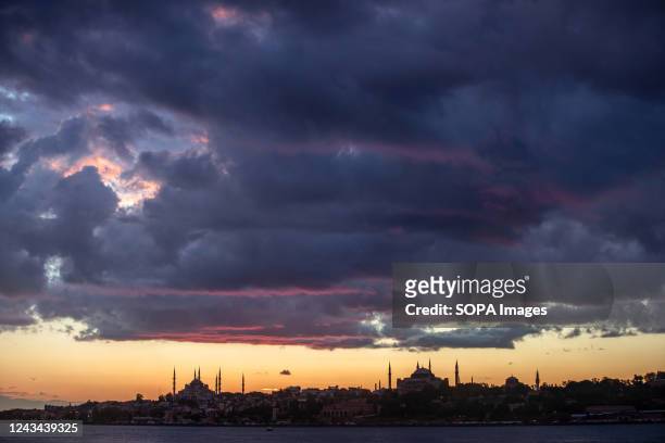 The silhouettes of the Hagia Sophia Mosque and the Blue Mosque during the sunset in Istanbul.