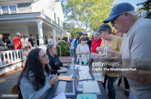 Edgartown MA Ed Morris and Jane Heflin , tourists on vacation from Chicago, made a cash donation for the undocumented immigrants just outside the...