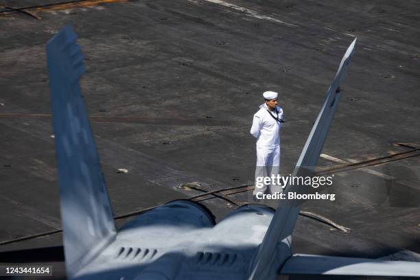 Member of the US Navy stands on board the USS Ronald Reagan, a Nimitz-class aircraft carrier and part of the US Navy 7th Fleet, anchored in Busan,...